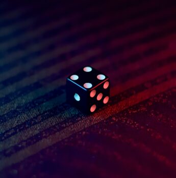 white and black dice on red textile